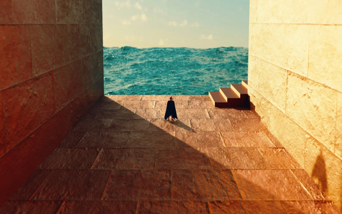 A small figure crossing a sunlit stone courtyard toward an opening onto the sea.
