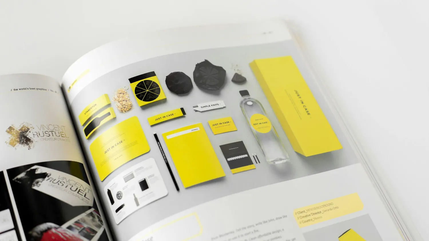A designer's hands arranging printed brand material across a desk.