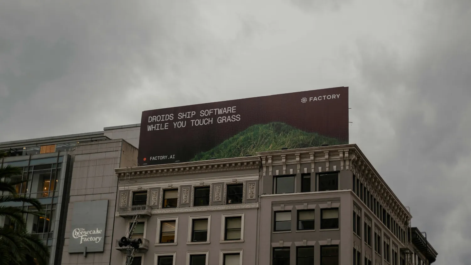 A large outdoor advertising hoarding above a city street.
