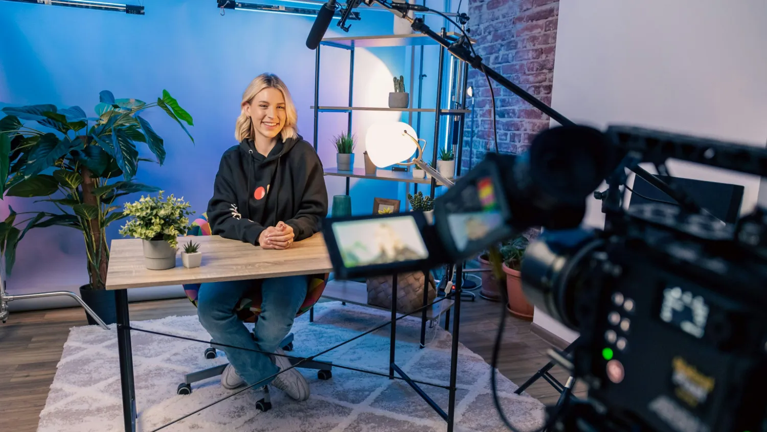 A woman being interviewed on camera in a studio.